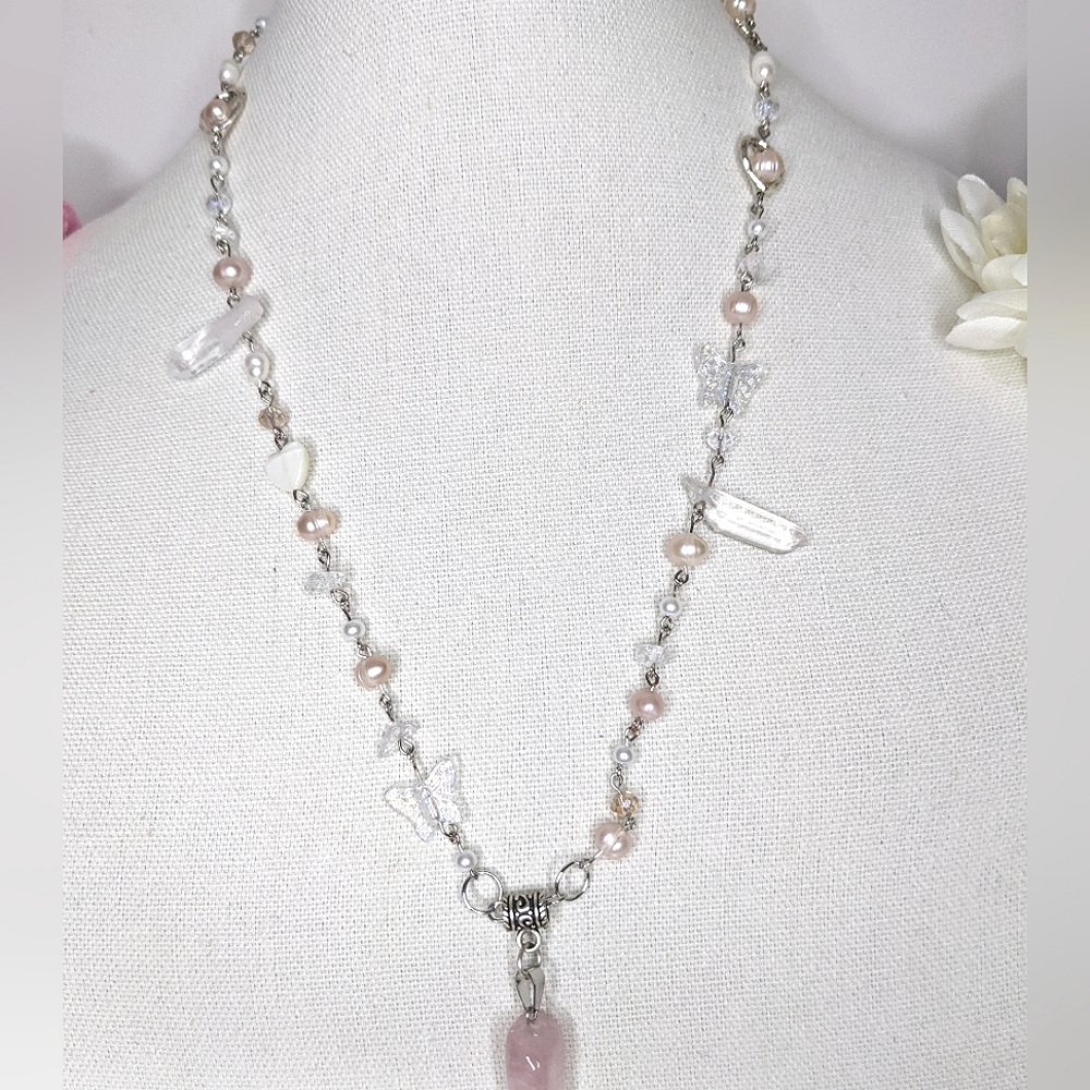 Necklace with a rose quartz pendant and coral colored pearls. Handmade by me.